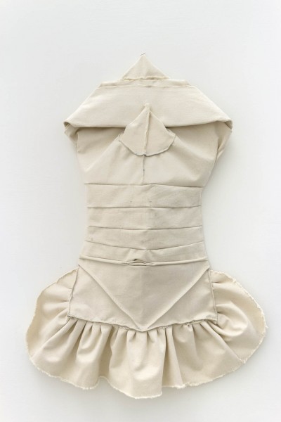 A front view of a woman's dress made of beige fabric with a corset.