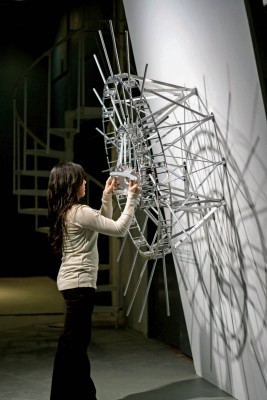 Joshua Kirsch working on the installation of her sculpture made out of metal.