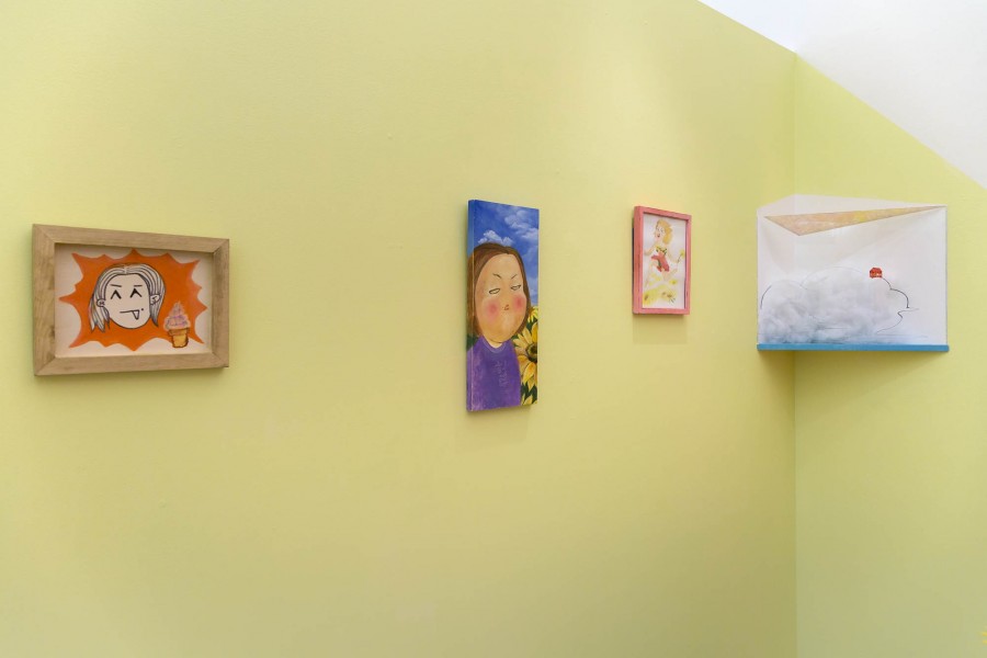 A view of four paintings, on the left, is a face with the tongue out on an orange background and an ice cream on the bottom right side. In the middle is a portrait with a woman dressed in violet and sunflower with the blue sky behind it. A full-body portrait of a blonde woman with a pink dress and sunflowers in the painting, and on the right side is a painting of an orange house far in the distance, and in front of it is a mist cloud.