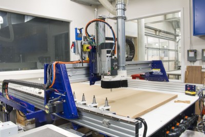 A view of the Shopbot CNC milling machine preparing to carve a sheet of acryllic.