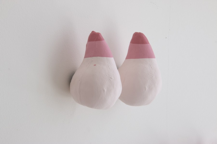 Two shapes like teardrops made of ceramic material and colored in white, and upper part colored with a dark red followed by a light pink then the body of the tear-shape is colored in white.