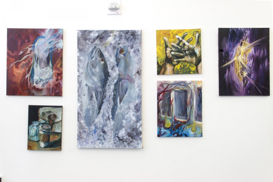 Six abstract paintings in a grid arrangement installed on a wall, representing different shapes and rounded organic linlinese with colors including silver, white, red, purple, yellow, etc.