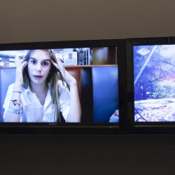 Three flat-screen TVs on the wall with images of a woman lying on the bed, a woman in an inn, and a woman in the park