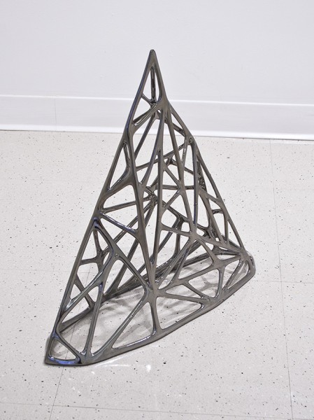 Metal sculpture made from lines with rounded angles.