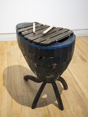 Sculpture of xylophone on three feet.