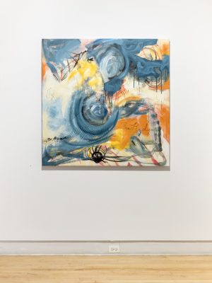 Install shot of abstract blue and orange painting. 