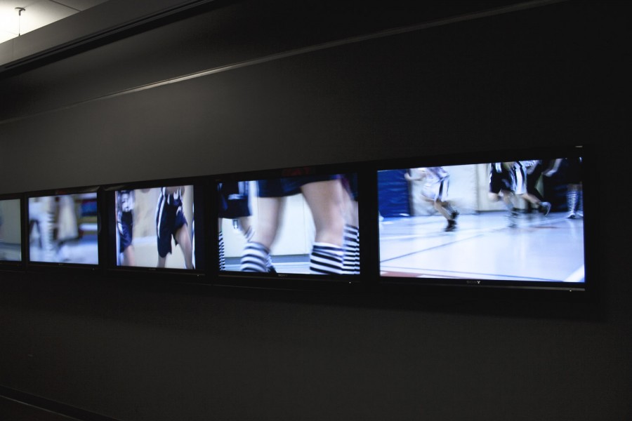 An array of TVs with multiple images from a sports game
