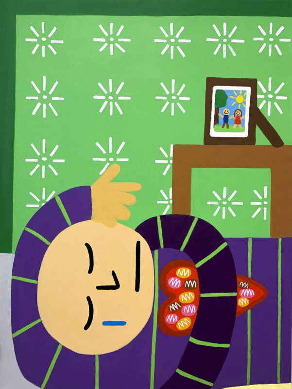 A light skin toned bald boy crying in bed with a blue tear down his face holding a heart box filled with chocolate. The background is filled with white flowers and a side with a picture of a couple framed outside.