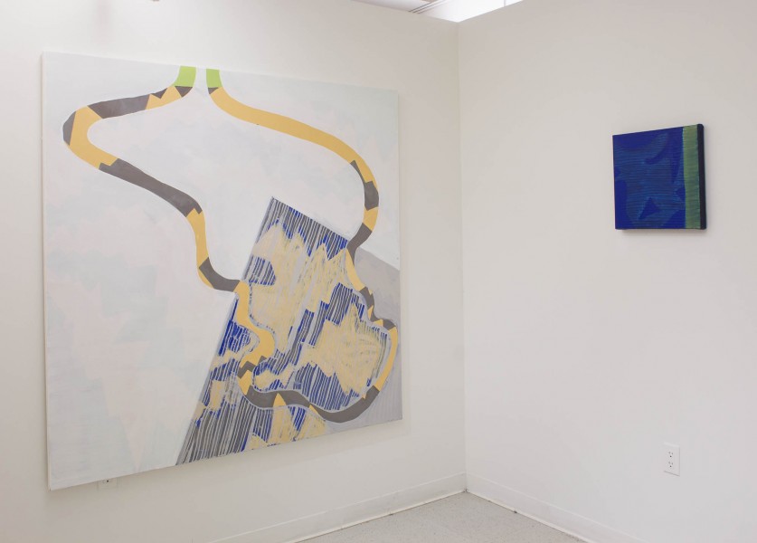Installation view of two abstract paintings. On the left is a painting of an angle part of a rectangle shape and two wavy lines going in the left and right of the painting. On the left side is a painting of a blue background with a vertical green stripe on the right part of the painting.