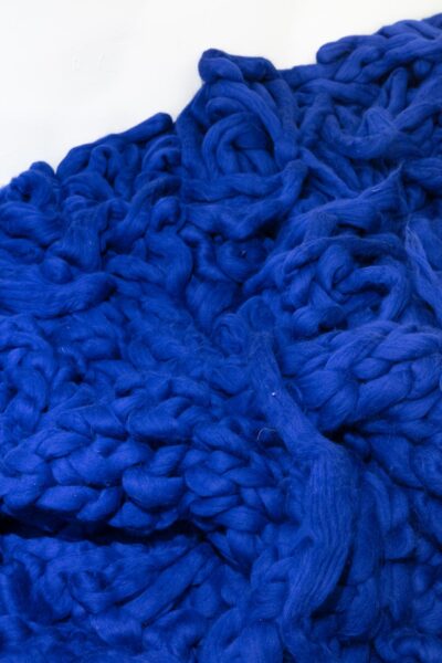 Detail of a pile of bright blue yarn.