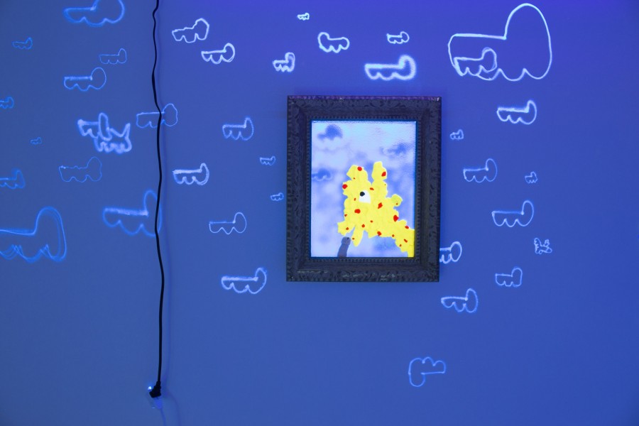 Small painting on the wall and many drawings lit up by neon light.