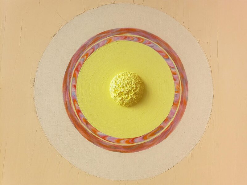 Detail of a yellow painting with a yellow circle in the center, surrounded by a pink circle.