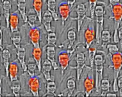 A digital collage of people in modern business clothes rendered in shades of gray with artifacts of digital image compression. Select faces are colored orange and blue.