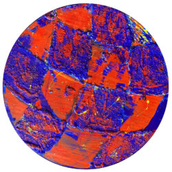 A painting by Ryan Cosbert. The painting is set on a circular wooden panel with acrylic paint in bright orange and blue colors with swirls of yellow paint across the surface.