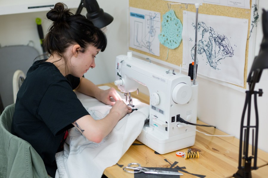 Student working with a sewing machine.