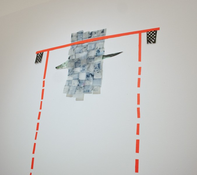 Neon orange tape stripes stick vertical with a dotted line and horizontal at the top of the vertical line in a fill line, two black basket mersh at the end of the horizontal line and a paper crocodile covered with small rectangular pieces of paper