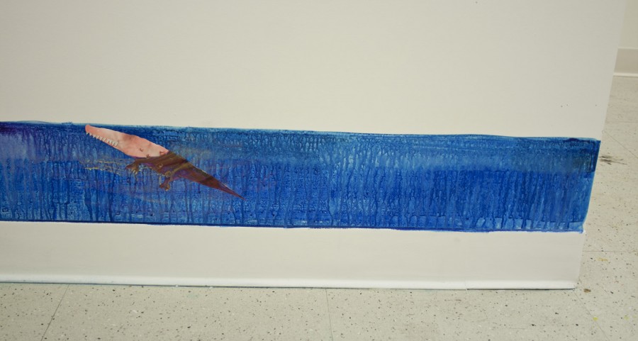 Blue paint stripe dripping on a wall with the shape of water and an orange crocodile;e with head above the water and rest of its body in water