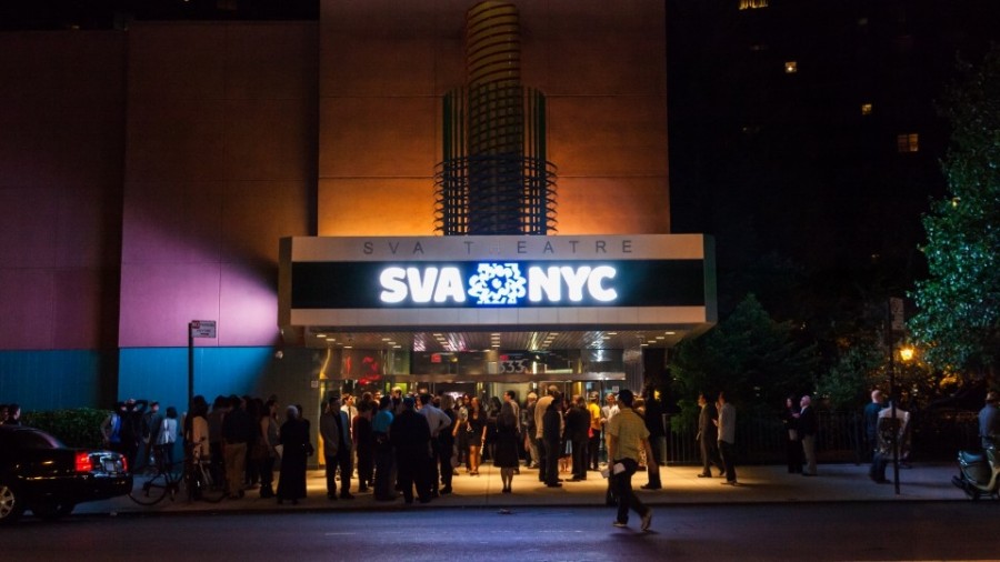SVA Theatre building at night with SVA NYC logo lit up and people gathering at the entrance