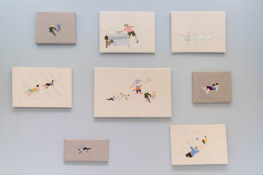 Installation vireo of eight embroideries representing people doing sport and dancing