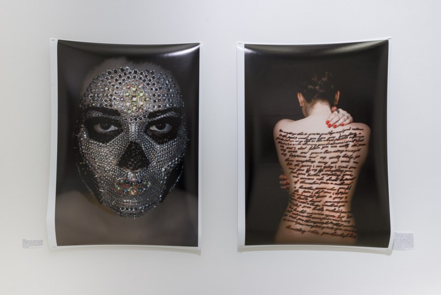A print of a person's face covered in tiny crystals and a back vire of a person with long text written on the entire back, from the shoulders to the lower back.