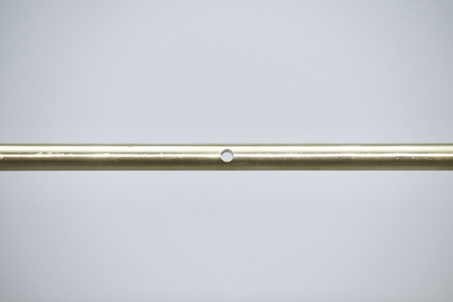 In a white gallery space there are two rectangular brass bars in the center near the rear wall. Identical in size, but slightly apart with height difference. Floating without any support.