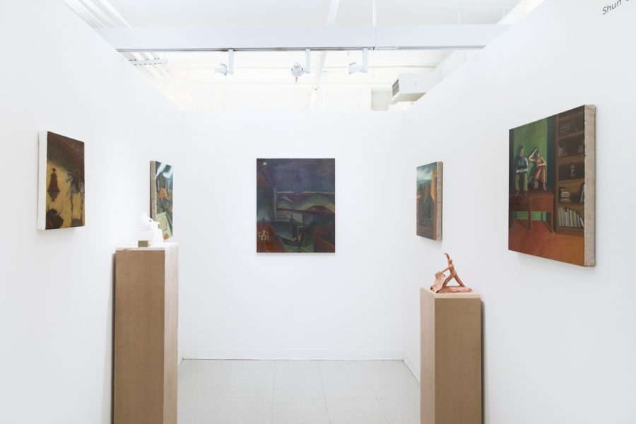 Installation view of artwork by Shunda Wan. Multiple paintings installed on three walls and two sculptures of figures on wooden pedestals.