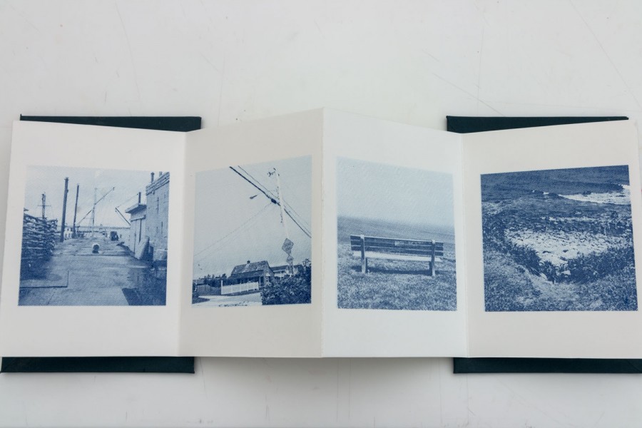 A brochure of four photographs with a street, an industrial area, an empty bench, and a landscape