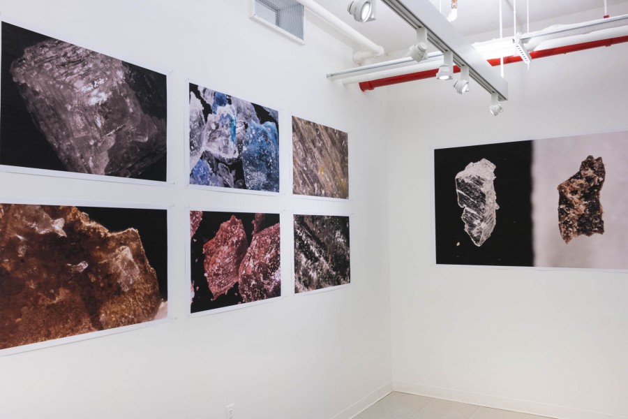 Exhibition view of seven prints representing close-ups of rock and crystal formations