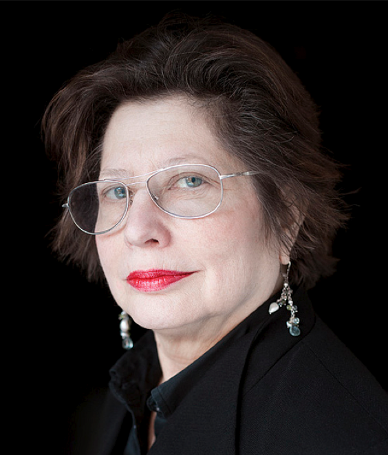 Headshot portrait of Suzanne Anker wearing glasses a black coat
