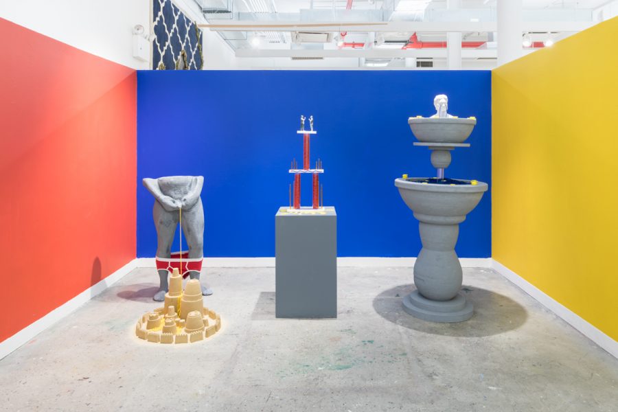 Installation view of artwork by Tony Seibert. A sculpture of a figure, fountain and trophy.