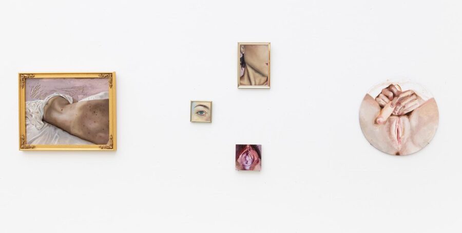 Installation view of paintings by Valeria Pezo showing various body parts.
