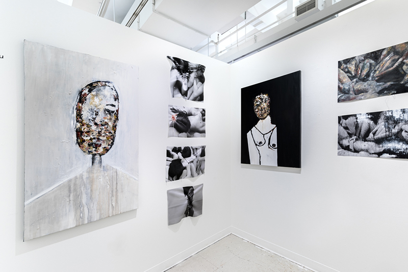 Installation view of artwork by Vasileia Anaxagorou. Two abstract paintings of a figure with a neutral tonal background, six photographs of different parts of the human body