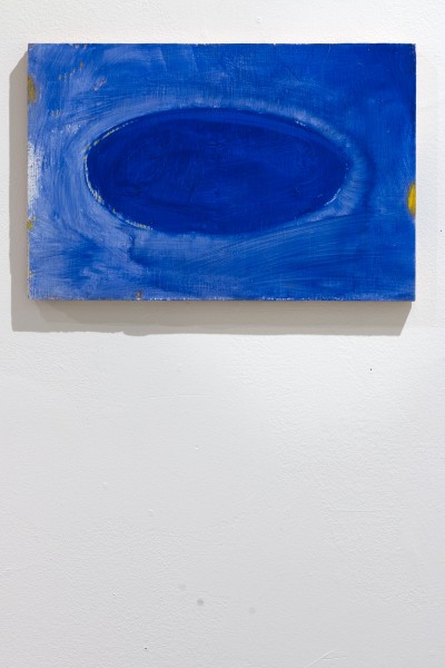 A painting of a dark blue horizontal oval on a lighter blue background.