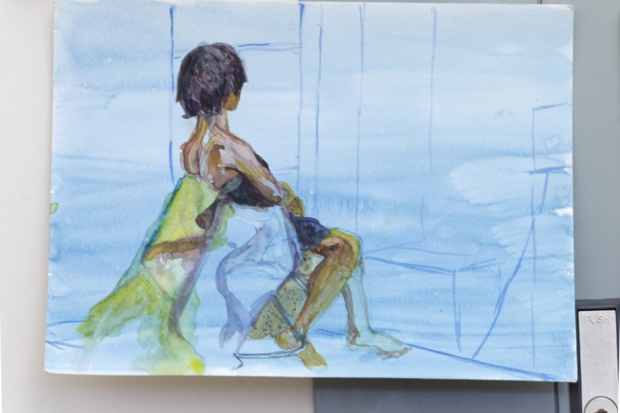 A painting made with watercolors illustrates a person sitting on a chair and facing away from the picture viewer. The where the person sits is painted in blue, the person skin is of dark color