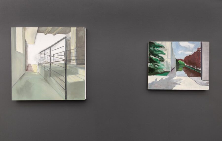 Installation view of Wu's studio during "Fall Open Studios" with two landscape paintings hanging on a grey wall.