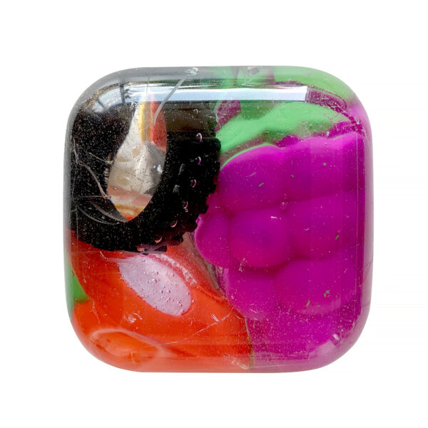 Small gummy toys are suspended in a smooth resin cast.