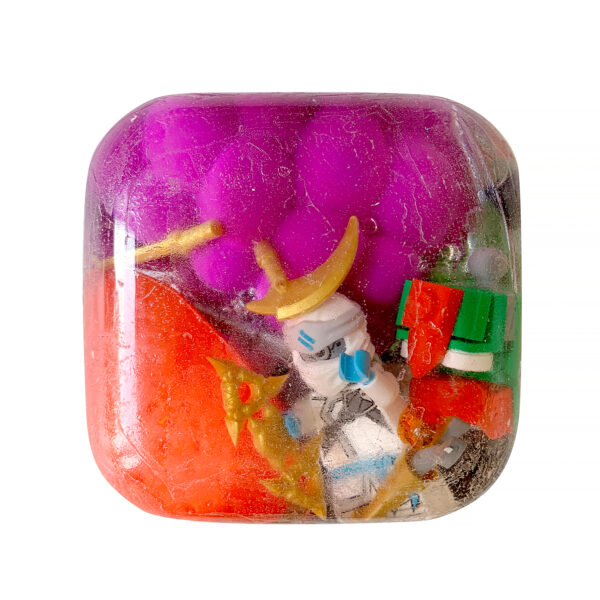 Small toys and colorful acrylic suspended in a clear resin cast.