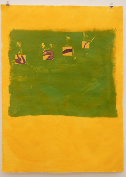 A green square is painted over a bright yellow background. Inside the square are four smaller squares. Inside each of these squares is a painted shape in a dark brown color. The painting is abstracted.