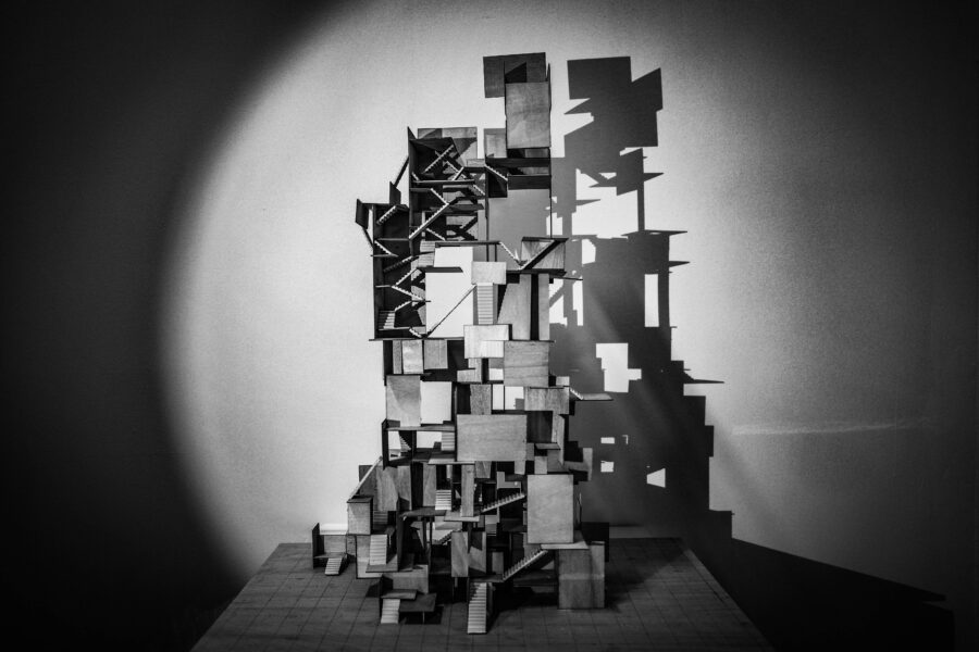 Black and white photo of an architectural model sculture using wood chips and clay