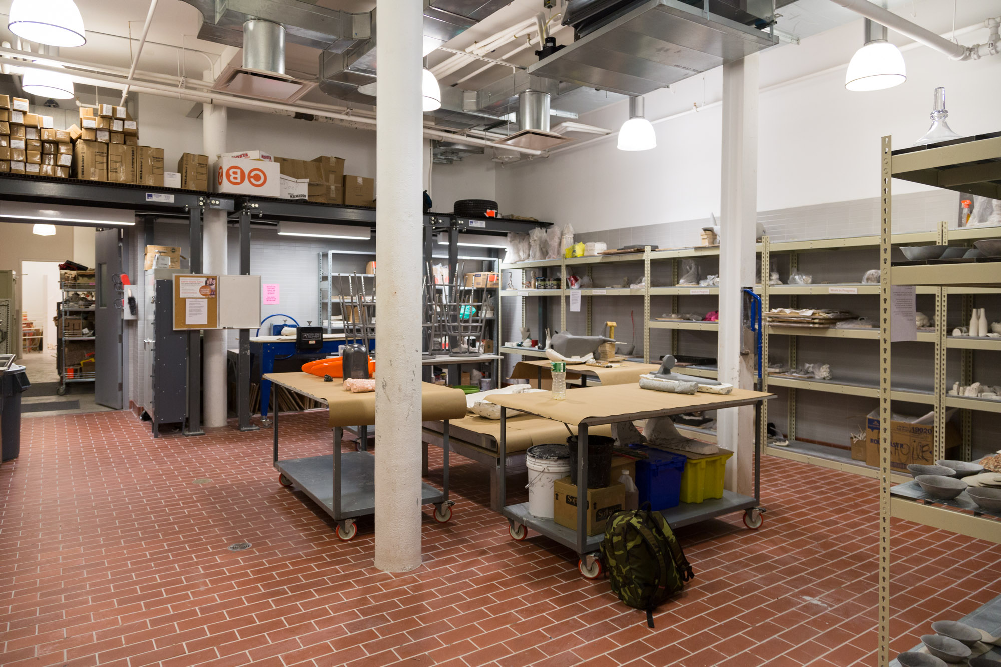 The ceramics workshop with large tables and shelves.