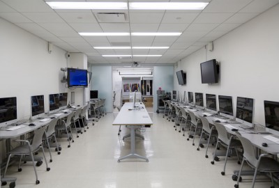A view of the main teaching computer lab showing 20 iMacs along the walls and a teaching computer in the center.