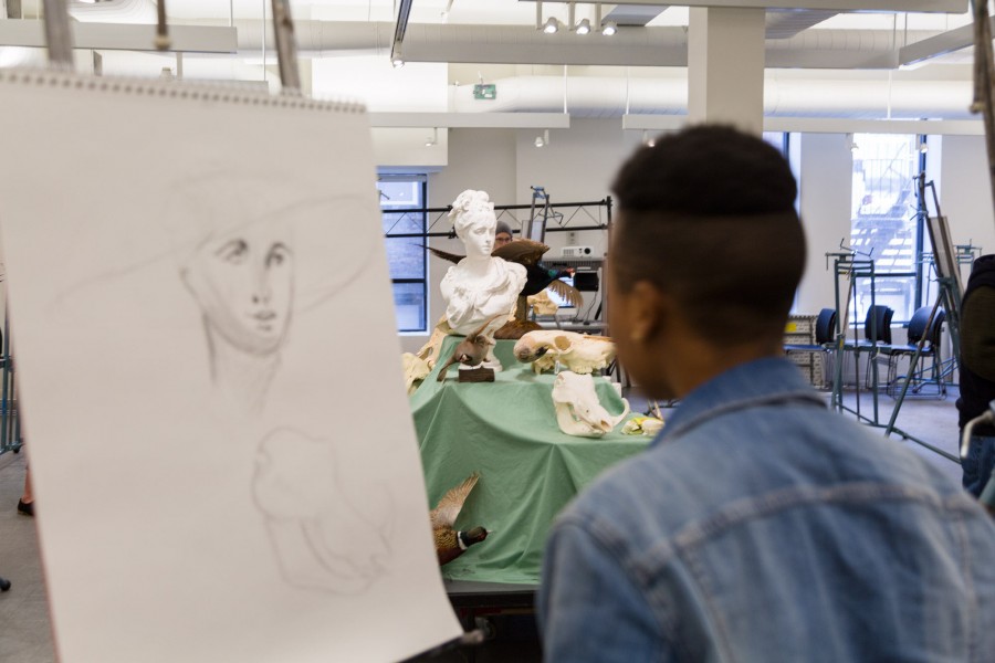 An SVA student in a drawing class and is drawing a model.