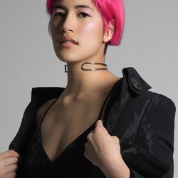 A photo portrait of Emma Sulkowicz with pink hair and a black coat.