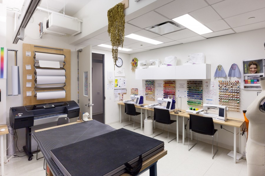An overview of the Fibers Lab with working tables, sewing machines, threads, digital embroidery machine.