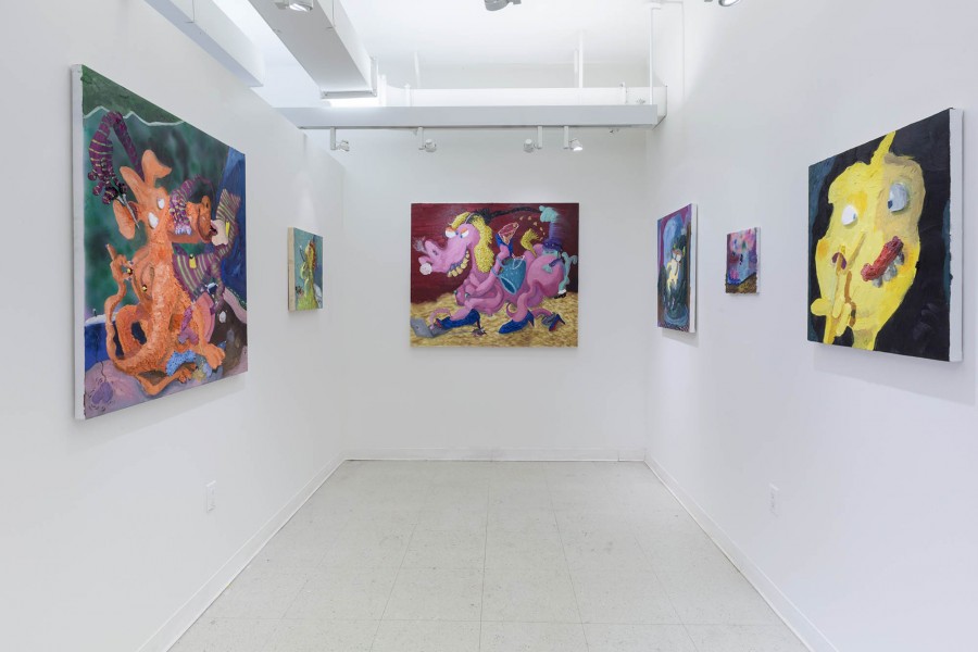 Installation view of a few paintings of different animal-like shapes in orange color, pink and yellow.