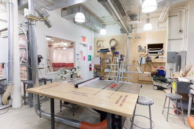 Sawstop table saw on front, wood lath and drill press on the left. Cleaning station, panel saw and Festool vacuum in the back.