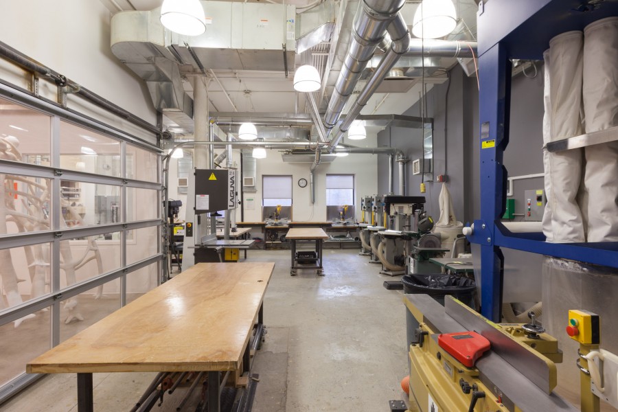 Overview of the woodshop with wooden tables and different working machines.