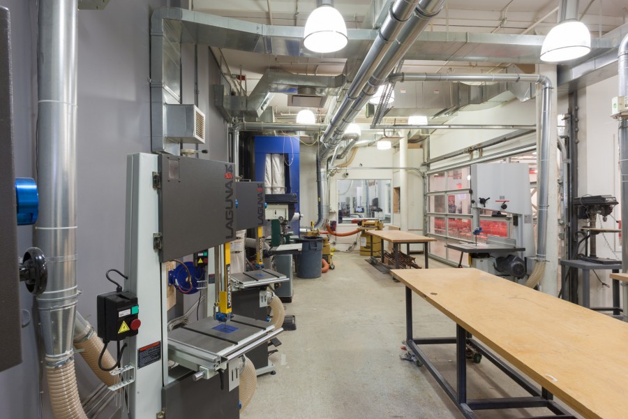 Band Saws on the left, working table and large band saw on the right, stationary sanding machine, blue dust collector, jointer and planer in the back