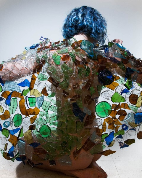 A back-view of a person with a smashed glass-made blanket.